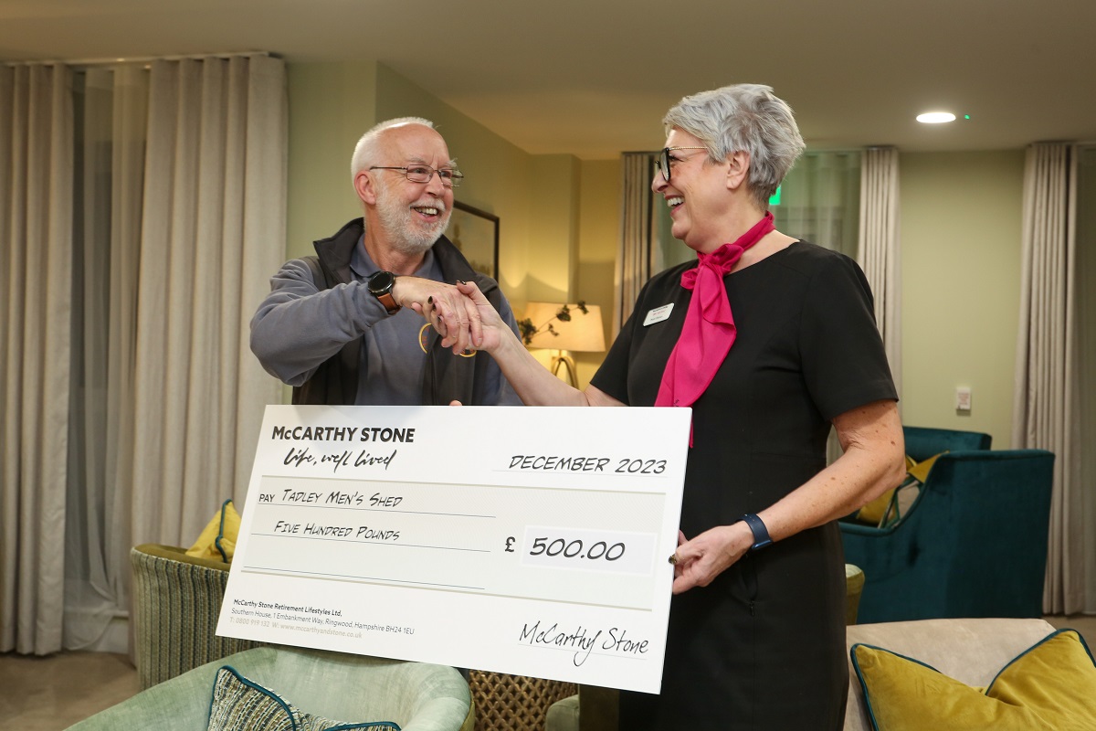 Paul Gross receiving a cheque